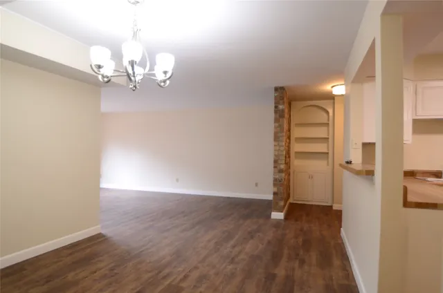 a kitchen with cabinets appliances a sink and a window