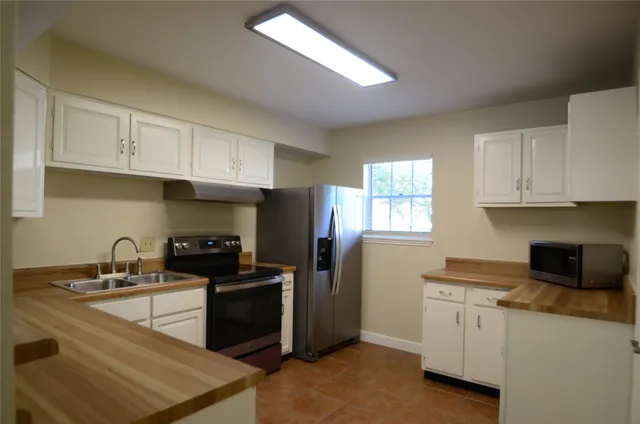 a view of wooden floor and cabinets in a room