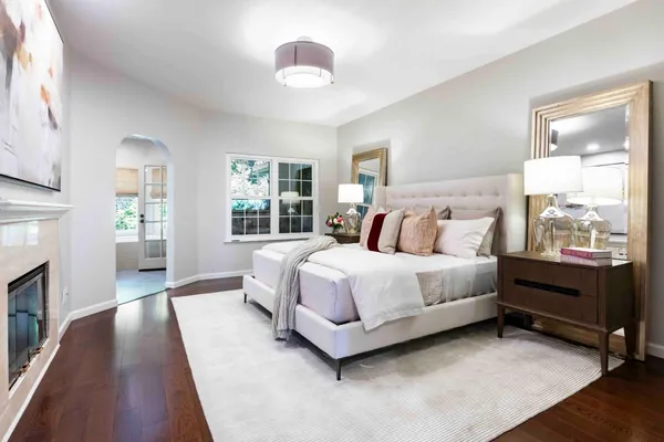 a spacious bedroom with a bed and a chandelier