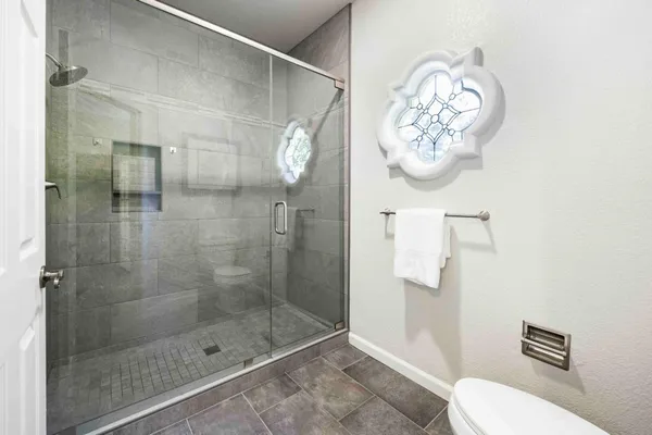 a bathroom with a toilet and a shower