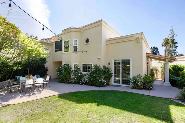 a view of a house with backyard and sitting area