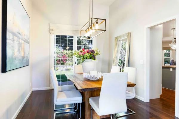 a view of a dining room with furniture and wooden floor