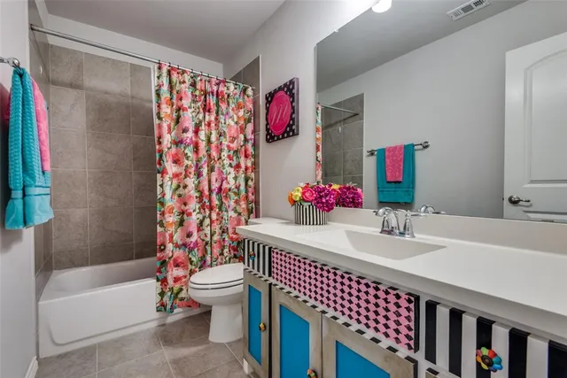 a bathroom with a bath tub a sink and a large mirror
