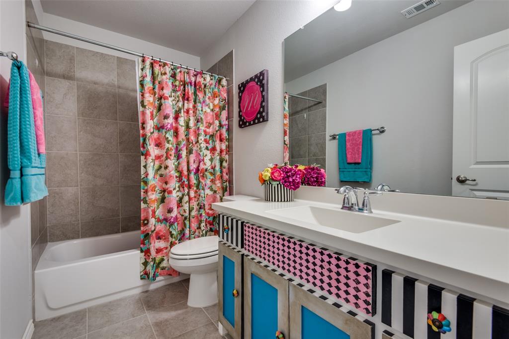 1320 Caliche Trail Allen, TX 75013 - Photo 22 of 25 a bathroom with a bath tub a sink and a large mirror