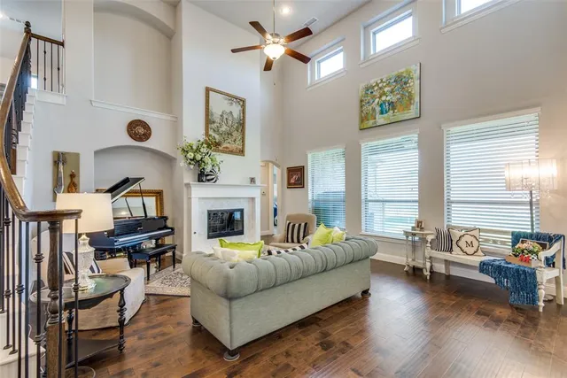 a living room with fireplace furniture and a large window
