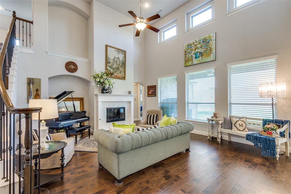 1320 Caliche Trail Allen, TX 75013 - Photo 9 of 25 a living room with fireplace furniture and a large window