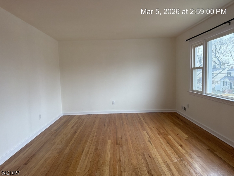 900 Smith Street, Unit 2 Linden, NJ 07036 - Photo 4 of 9 an empty room with wooden floor and windows