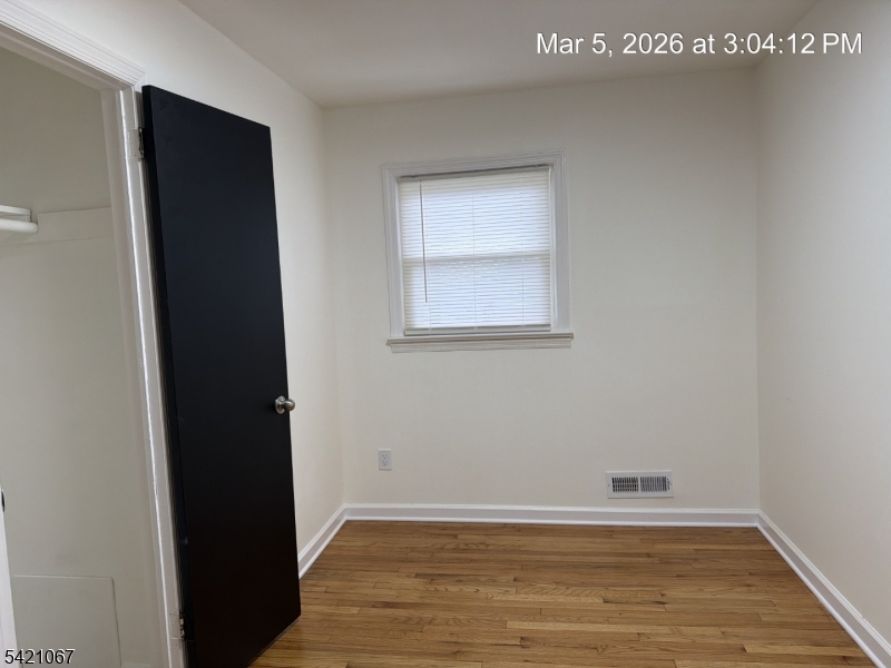 900 Smith Street, Unit 2 Linden, NJ 07036 - Photo 9 of 9 an empty room with wooden floor and a window