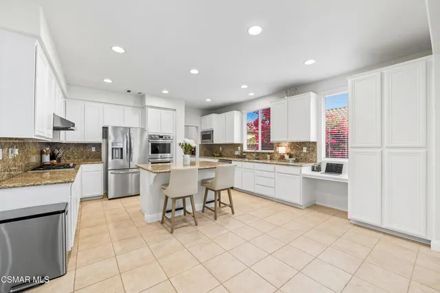 a kitchen with a white cabinets and counter space
