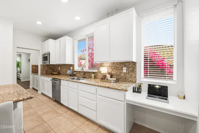 a kitchen with stainless steel appliances granite countertop a sink and a stove