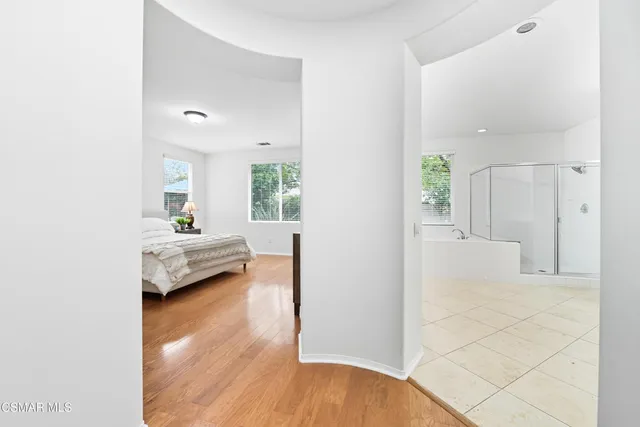a bedroom with a bed and a view of bathroom