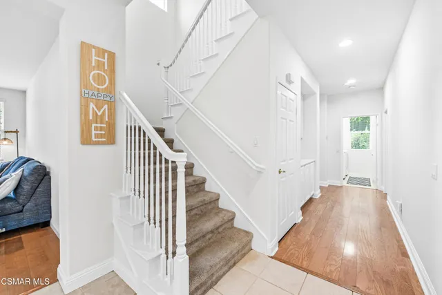 a view of entryway and hall with wooden floor