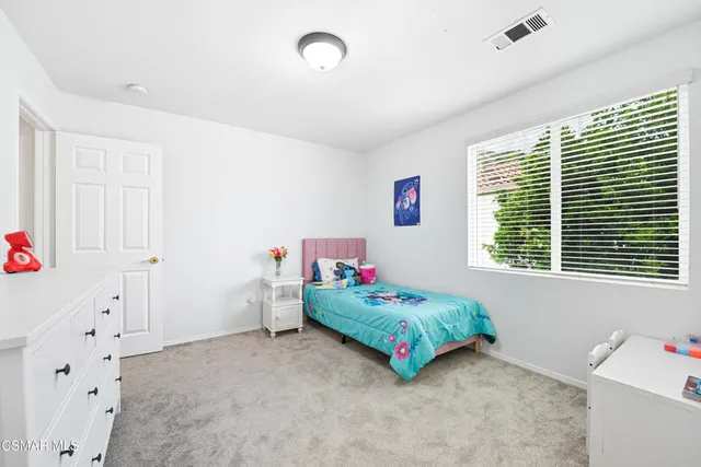 a bedroom that has a bed and a window