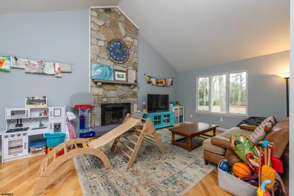 a living room with furniture and a book shelf