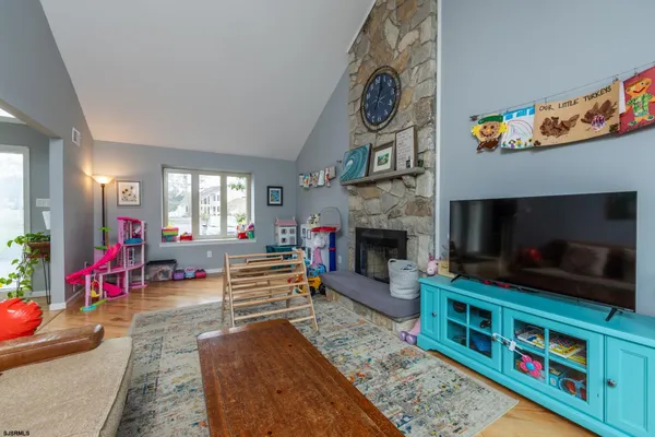 a bathroom with a granite countertop sink vanity mirror and toilet