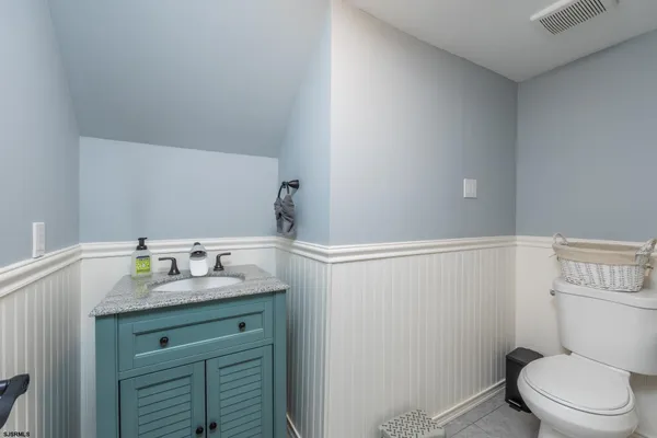 a large kitchen with stainless steel appliances granite countertop a stove a sink dishwasher and a fireplace with wooden floor