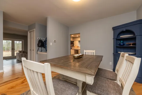 a large kitchen with cabinets and wooden floor
