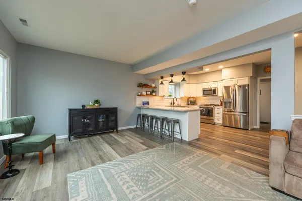 a bedroom with a bed a books and a bookshelf with wooden cabinet