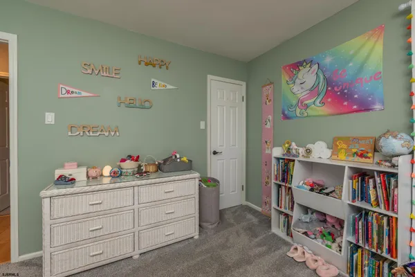 a bedroom with two beds and a flat screen tv