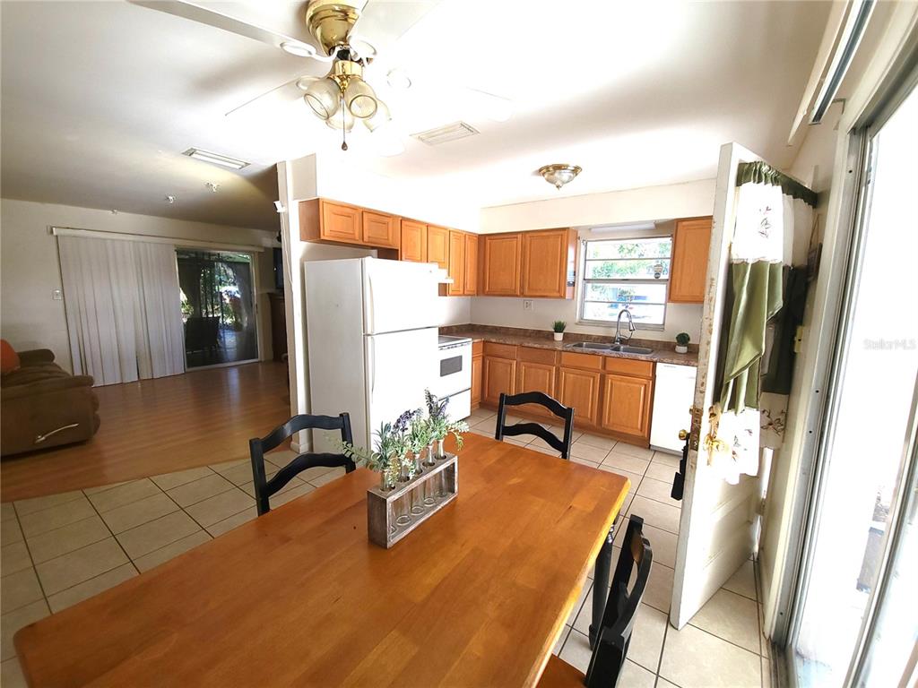 516 B Track Run Ocala, FL 34472 - Photo 12 of 41 a dining room with stainless steel appliances furniture a rug and a chandelier