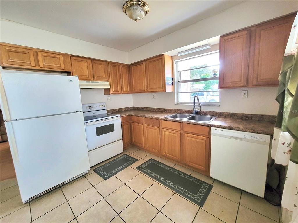 516 B Track Run Ocala, FL 34472 - Photo 13 of 41 a kitchen with a refrigerator sink and cabinets