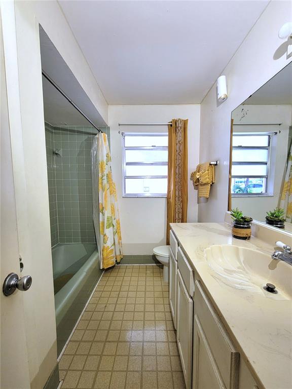 516 B Track Run Ocala, FL 34472 - Photo 14 of 41 a bathroom with a granite countertop sink a toilet and shower