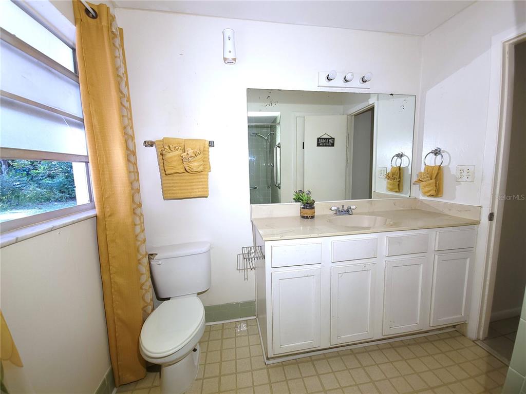 516 B Track Run Ocala, FL 34472 - Photo 15 of 41 a bathroom with a granite countertop toilet sink and mirror