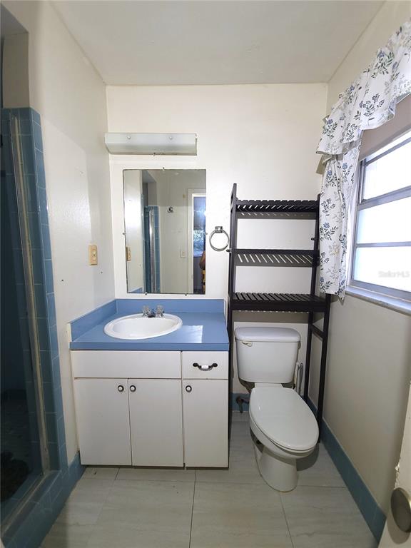 516 B Track Run Ocala, FL 34472 - Photo 20 of 41 a bathroom with a toilet a sink and mirror