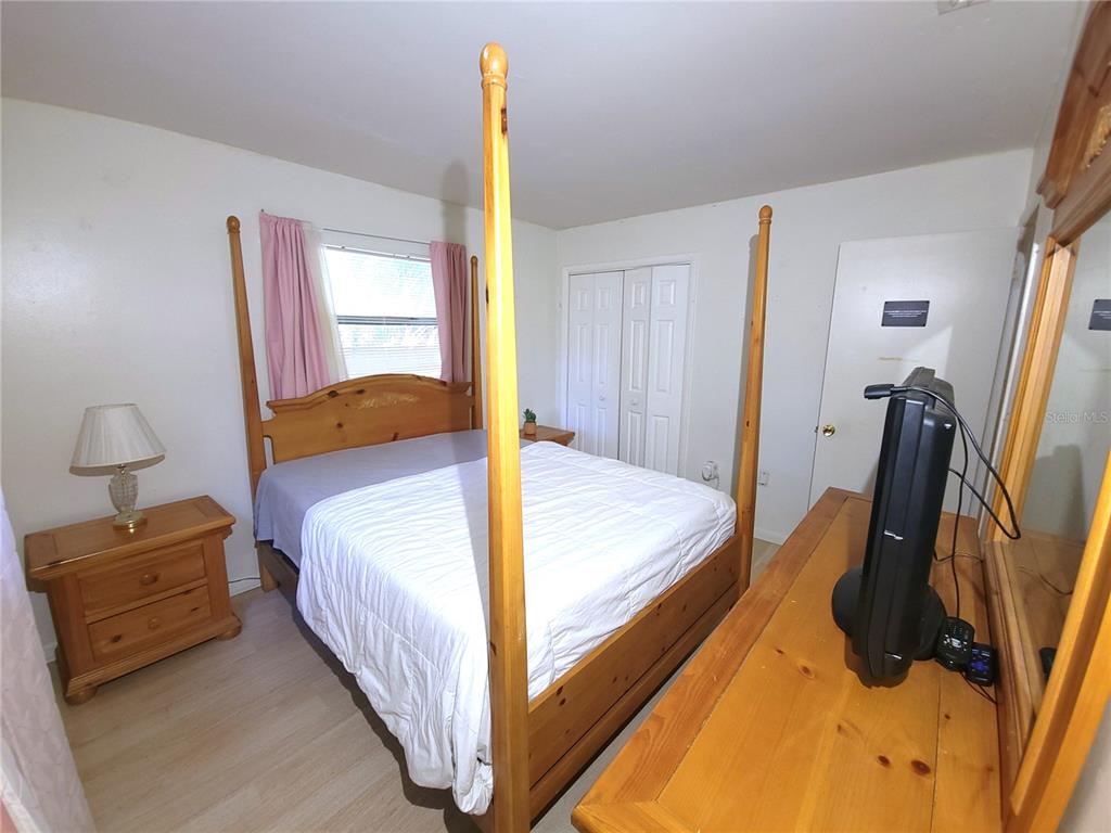 516 B Track Run Ocala, FL 34472 - Photo 23 of 41 a bedroom with a bed and wooden floor