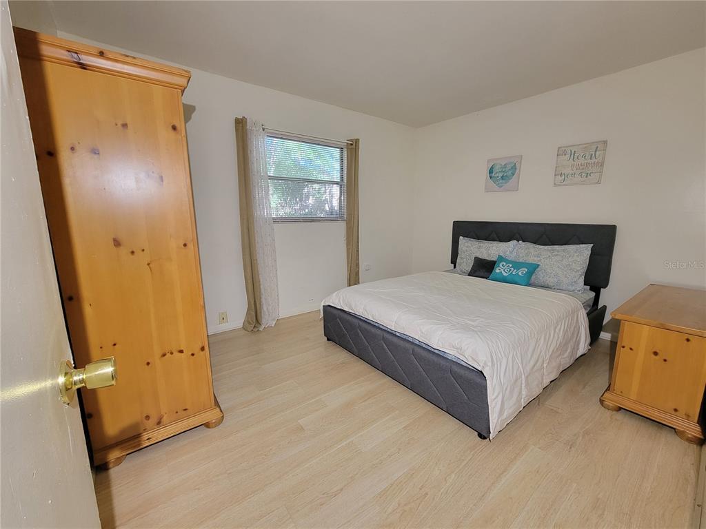 516 B Track Run Ocala, FL 34472 - Photo 24 of 41 a bed room with a bed and a mirror