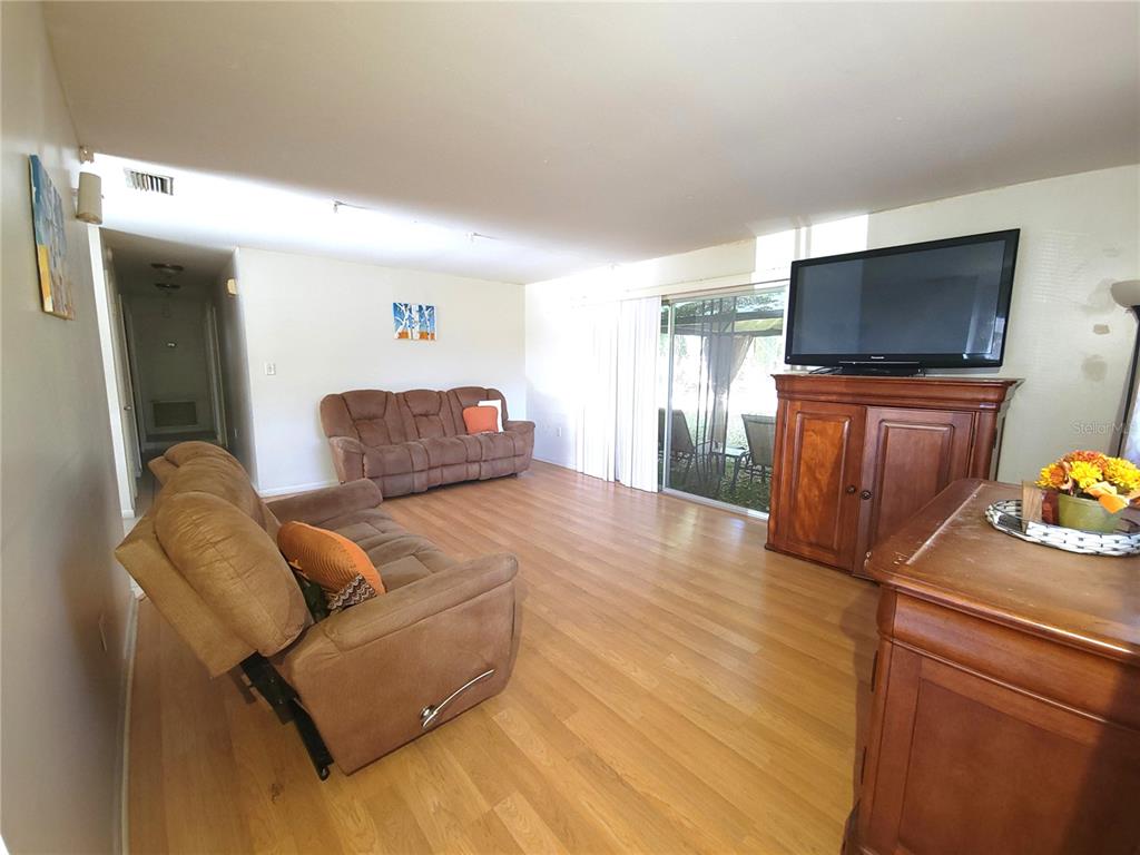 516 B Track Run Ocala, FL 34472 - Photo 8 of 41 a living room with furniture and a flat screen tv