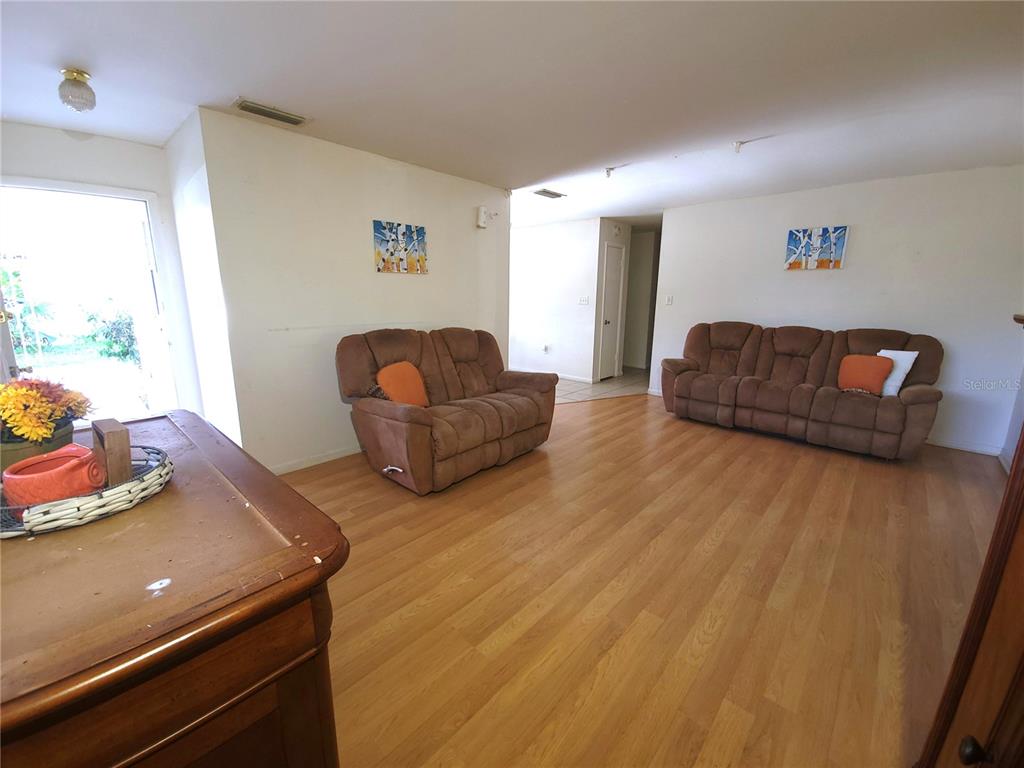 516 B Track Run Ocala, FL 34472 - Photo 9 of 41 a living room with furniture and a wooden floor