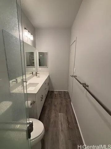 a spacious bathroom with a sink a toilet a mirror and bathtub