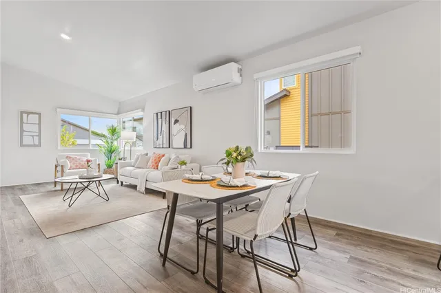 a view of a livingroom and dining room with wooden floor kitchen view
