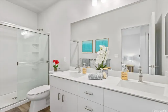 a bathroom with a sink vanity mirror and toilet