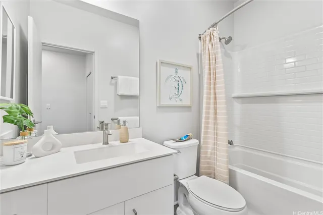 a bathroom with a sink a toilet a mirror and shower