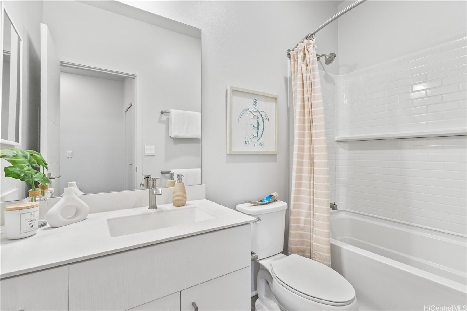 91-1816 Kohanahana Loop Ewa Beach, HI 96706 - Photo 24 of 25 a bathroom with a sink a toilet a mirror and shower