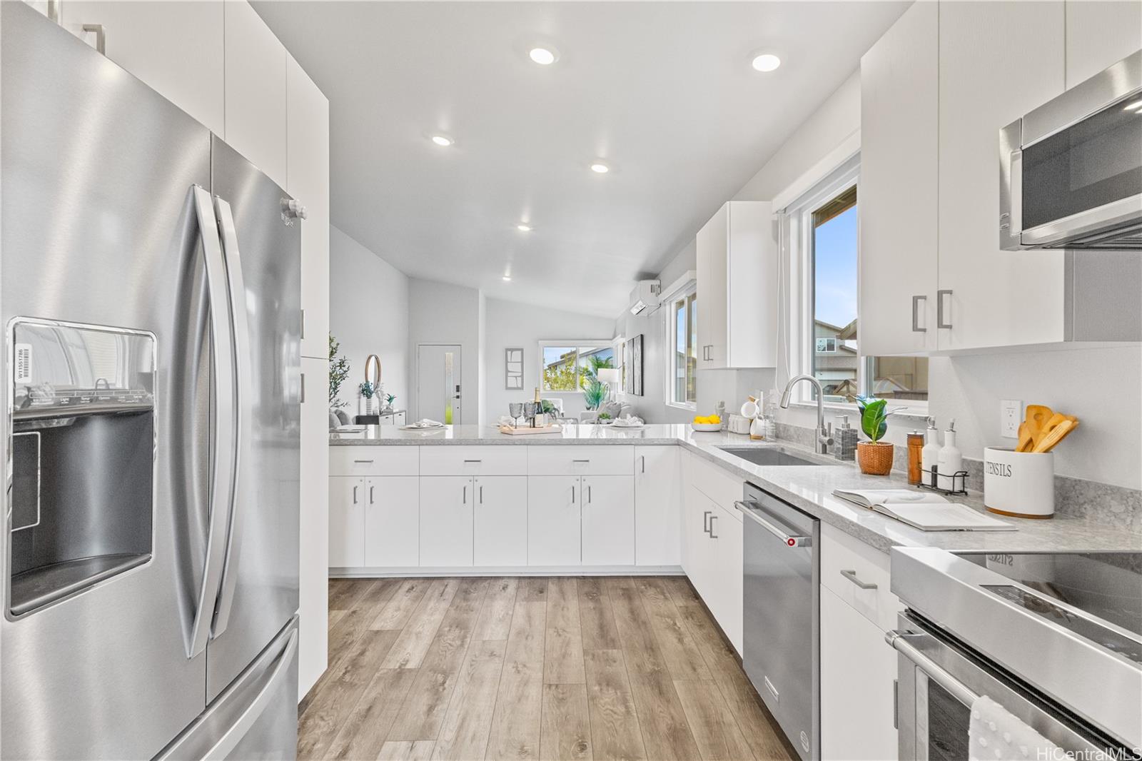 91-1816 Kohanahana Loop Ewa Beach, HI 96706 - Photo 25 of 25 a kitchen with white cabinets and stainless steel appliances