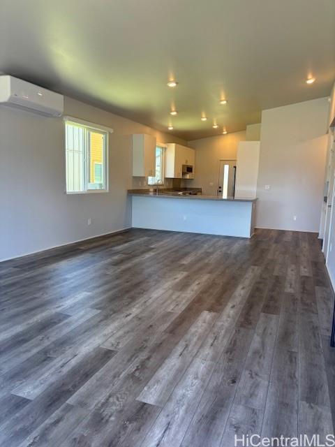 91-1816 Kohanahana Loop Ewa Beach, HI 96706 - Photo 4 of 25 a view of kitchen with kitchen island a sink wooden floor and a fireplace