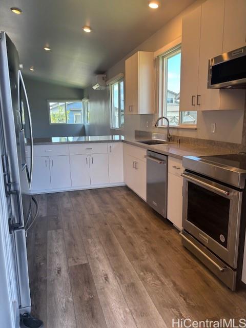 91-1816 Kohanahana Loop Ewa Beach, HI 96706 - Photo 6 of 25 a large kitchen with stainless steel appliances granite countertop a stove a sink and a granite countertops with wooden floor