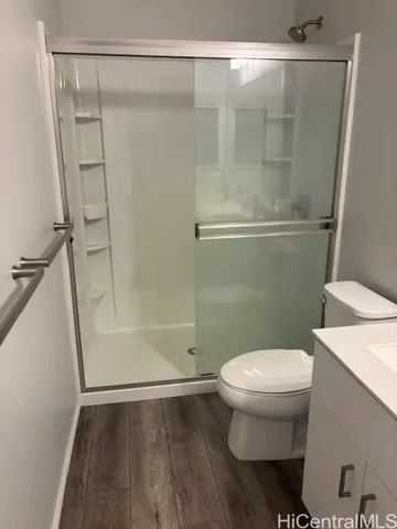 a bathroom with a toilet and a shower