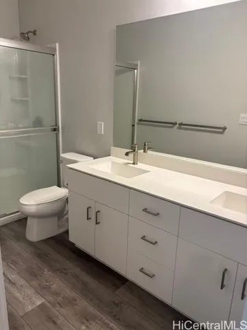 a bathroom with a double vanity sink toilet and a mirror