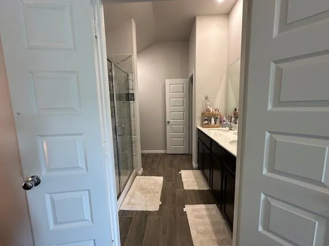 a bathroom with a sink a mirror and a shower