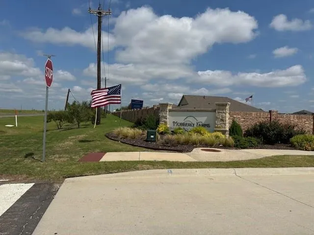 a front view of a house with a garden and plants