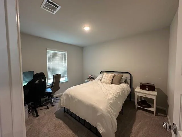 a bedroom with a bed and a table