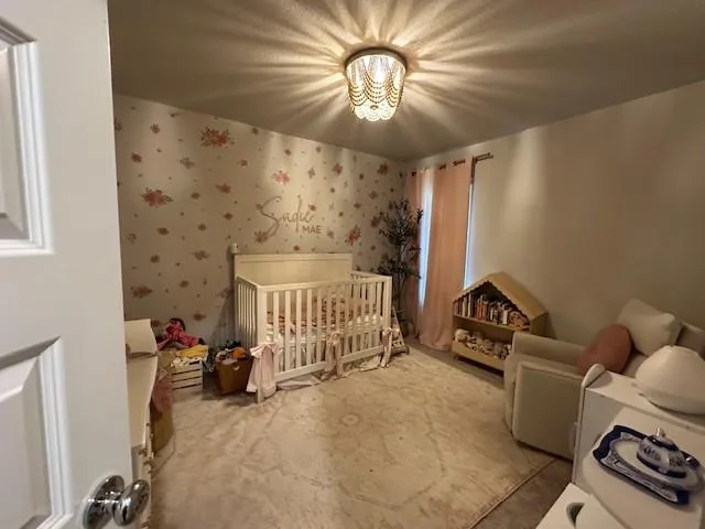 a bedroom with furniture and a chandelier