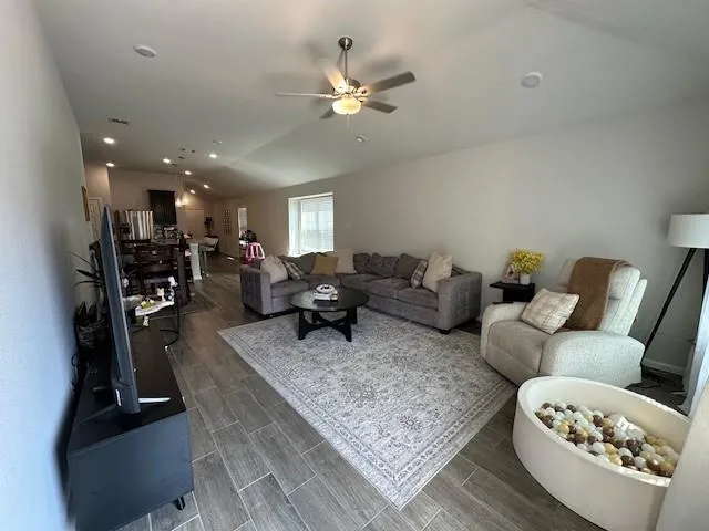 a living room with furniture and a chandelier