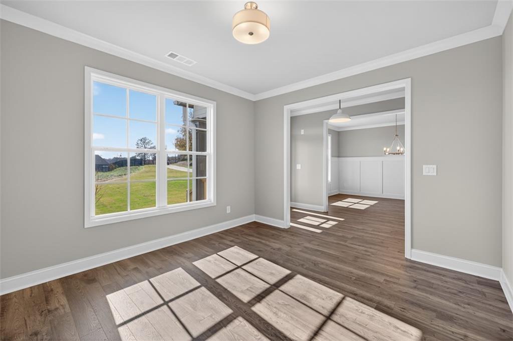 8845 Jot Em Down Road Gainesville, GA 30506 - Photo 11 of 87 a view of an empty room with wooden floor and a window