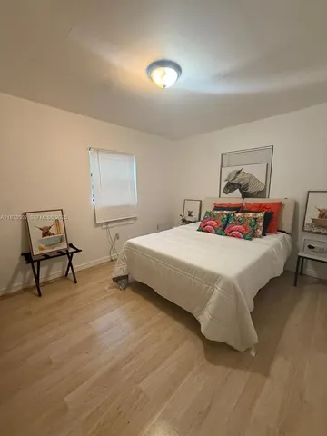 a bedroom with a bed and a lamp on table