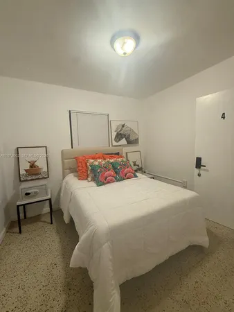 a bedroom with a bed and a night stand